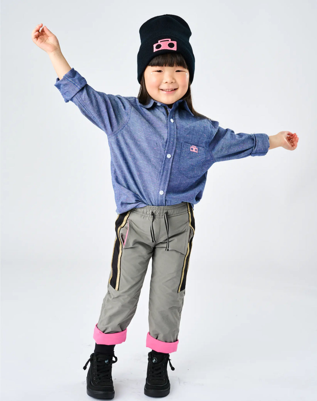 Child wearing StereoType Kids Boombox Beanie in black with hot pink Boombox patch, Chambray Button-Down Zip Shirt and Active Pant, unisex kids and adult knit beanie made in the USA