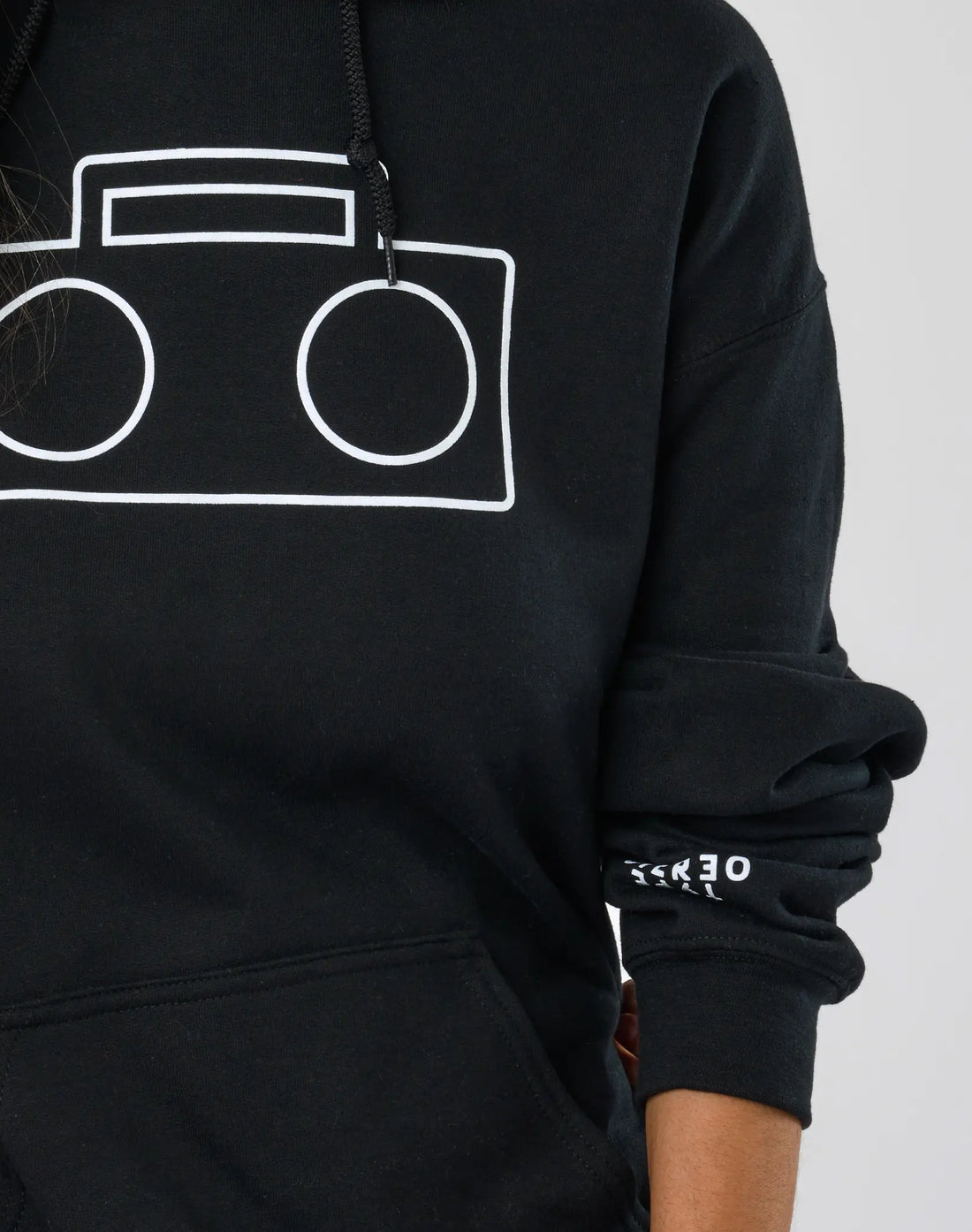Close-up of StereoType Kids black adult Boombox Logo Hoodie showing white boombox outline graphic and STEREO TYPE sleeve print detail