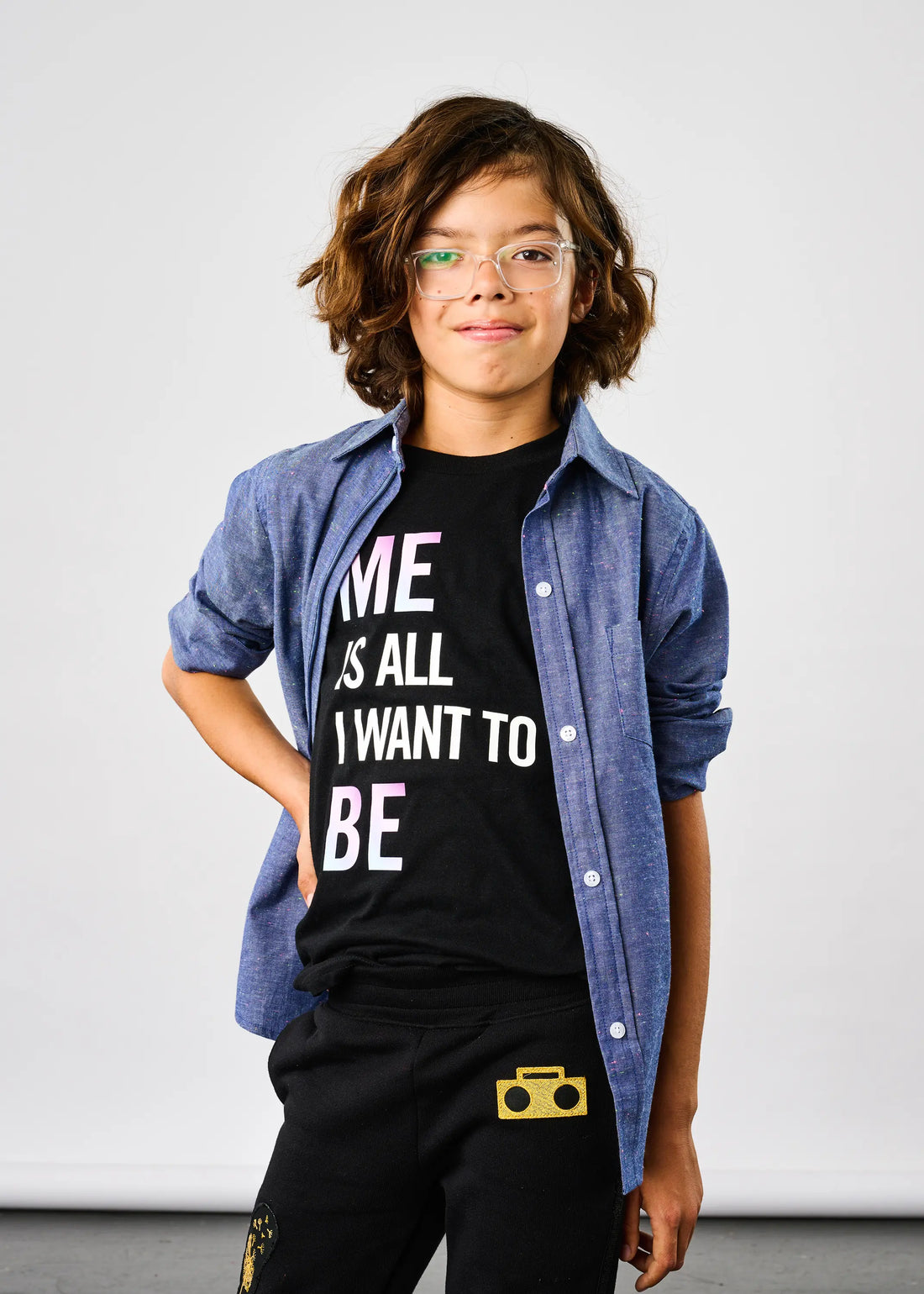 Child wearing StereoType Kids Me Is All I Want To Be holographic title tee in black layered under Chambray Button-Down Zip Shirt