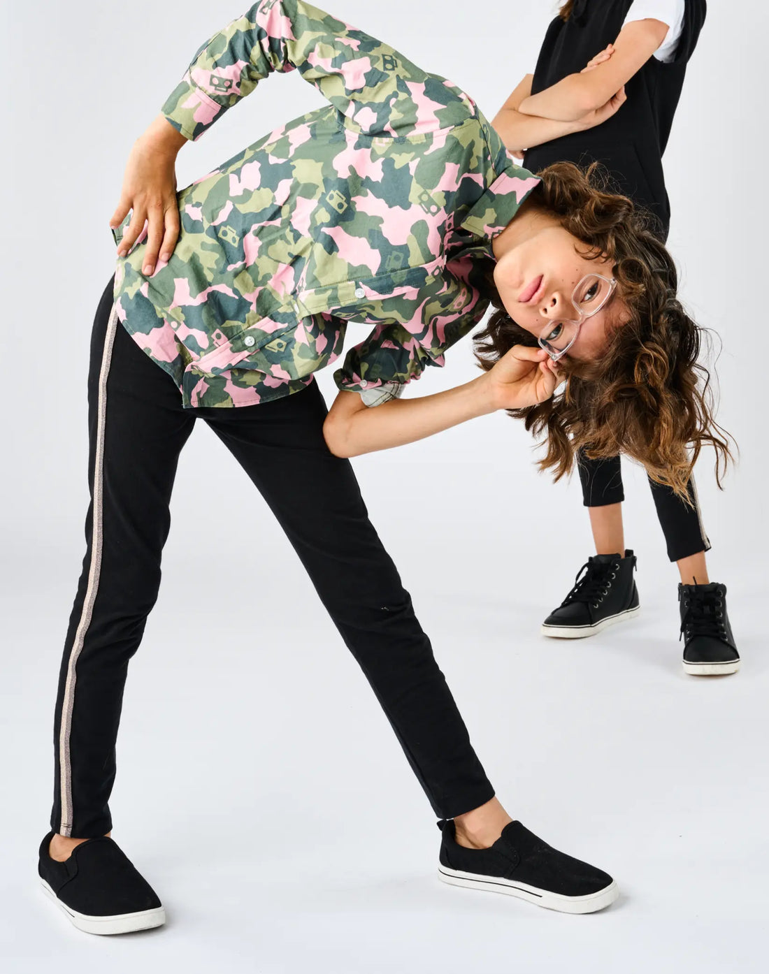 StereoType Kids co-founders Chloe and Jacob wearing Sparkle Leggings in black with gold sparkle stripe, holding hands, unisex kids gender-inclusive leggings designed in San Francisco
