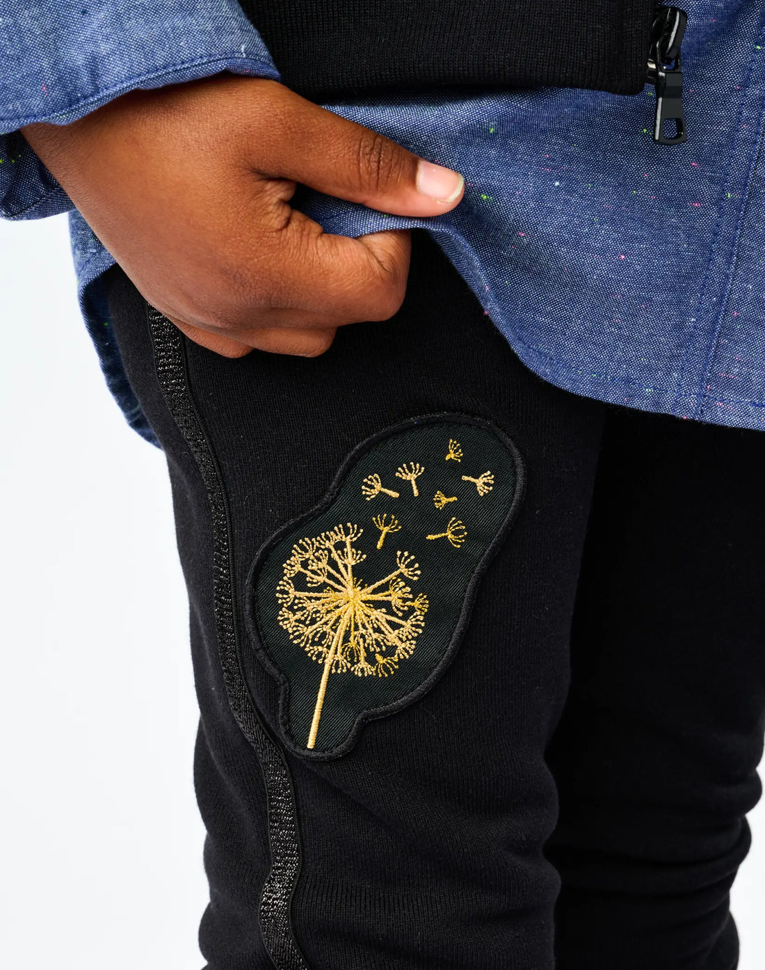 Stereotype Kids Boombox Knit Sweats closeup of gold embroidered dandelion patch on black recycled knit fleece