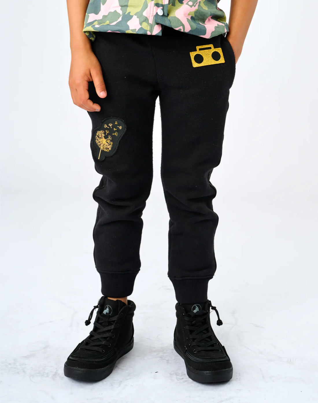 Stereotype Kids Boombox Knit Sweats front view showing gold boombox patch, embroidered dandelion knee patch and ribbed cuffs