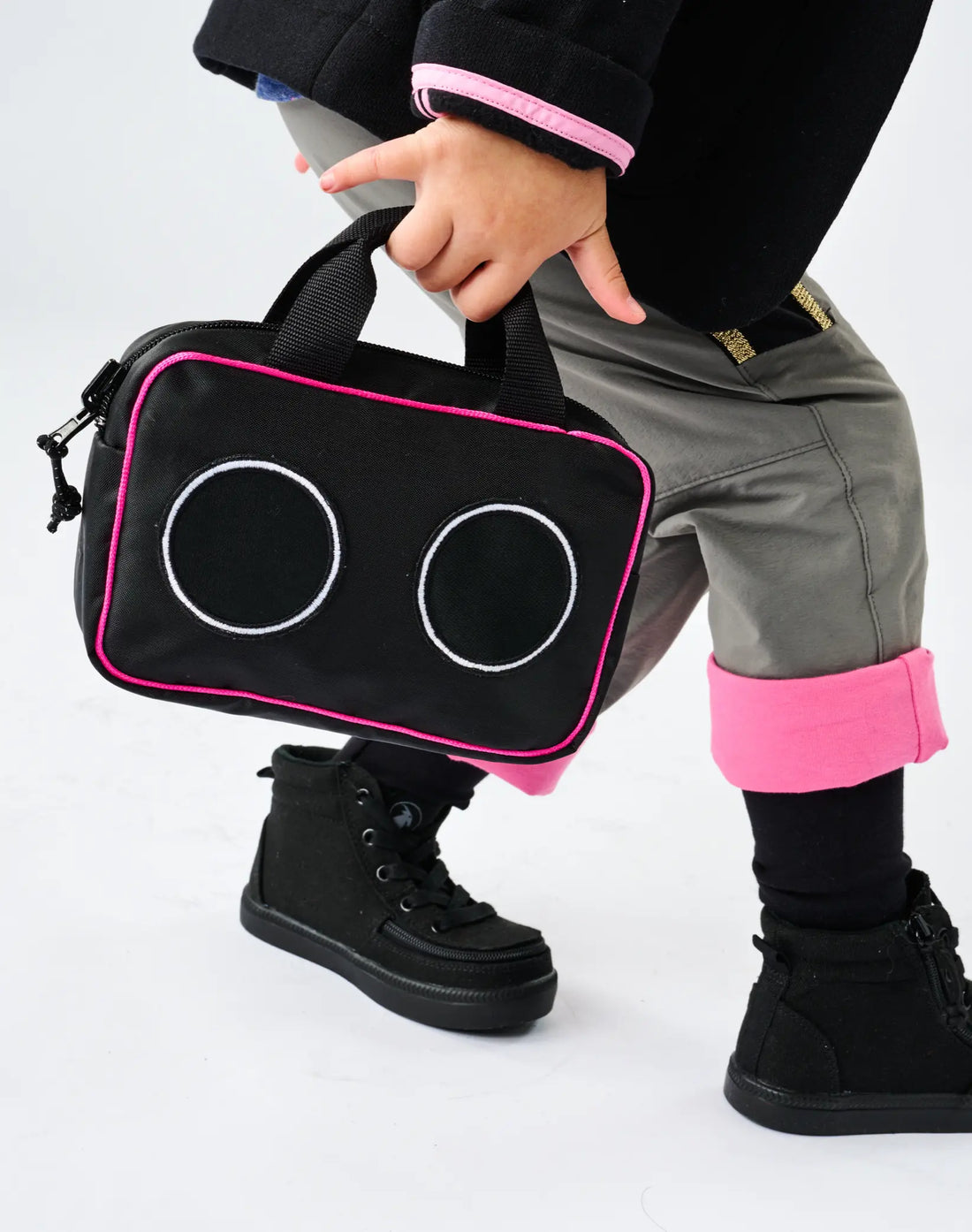Stereotype Kids Boombox Treasure Bag in black with hot pink trim and boombox speaker detail, carried by handle