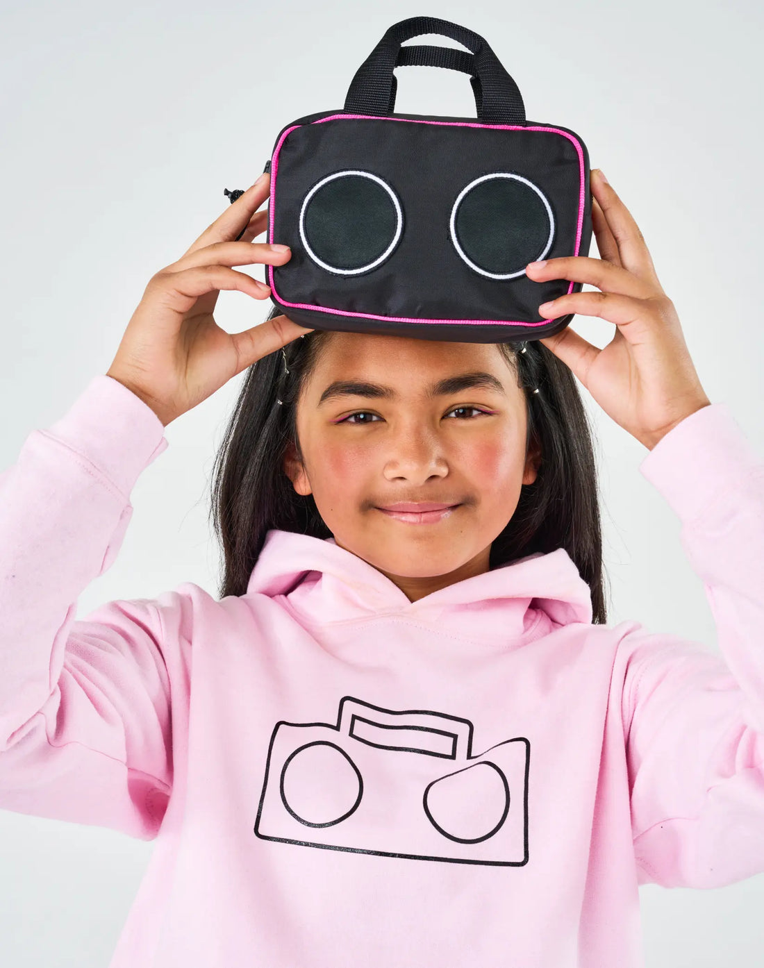 Stereotype Kids Boombox Treasure Bag balanced on head by girl in pink boombox hoodie