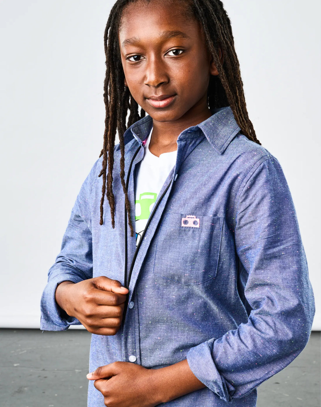 Stereotype Kids Chambray Button-down Zip Shirt buttoned up showing boombox pocket patch and zip closure detail