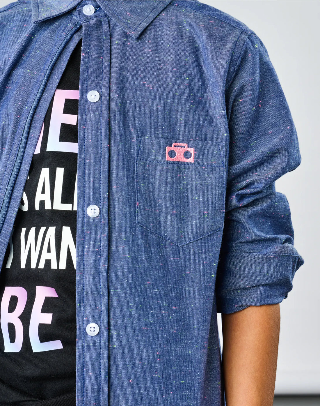 Stereotype Kids Chambray Button-down Zip Shirt closeup of pink embroidered boombox logo patch on neon speckle cotton chambray