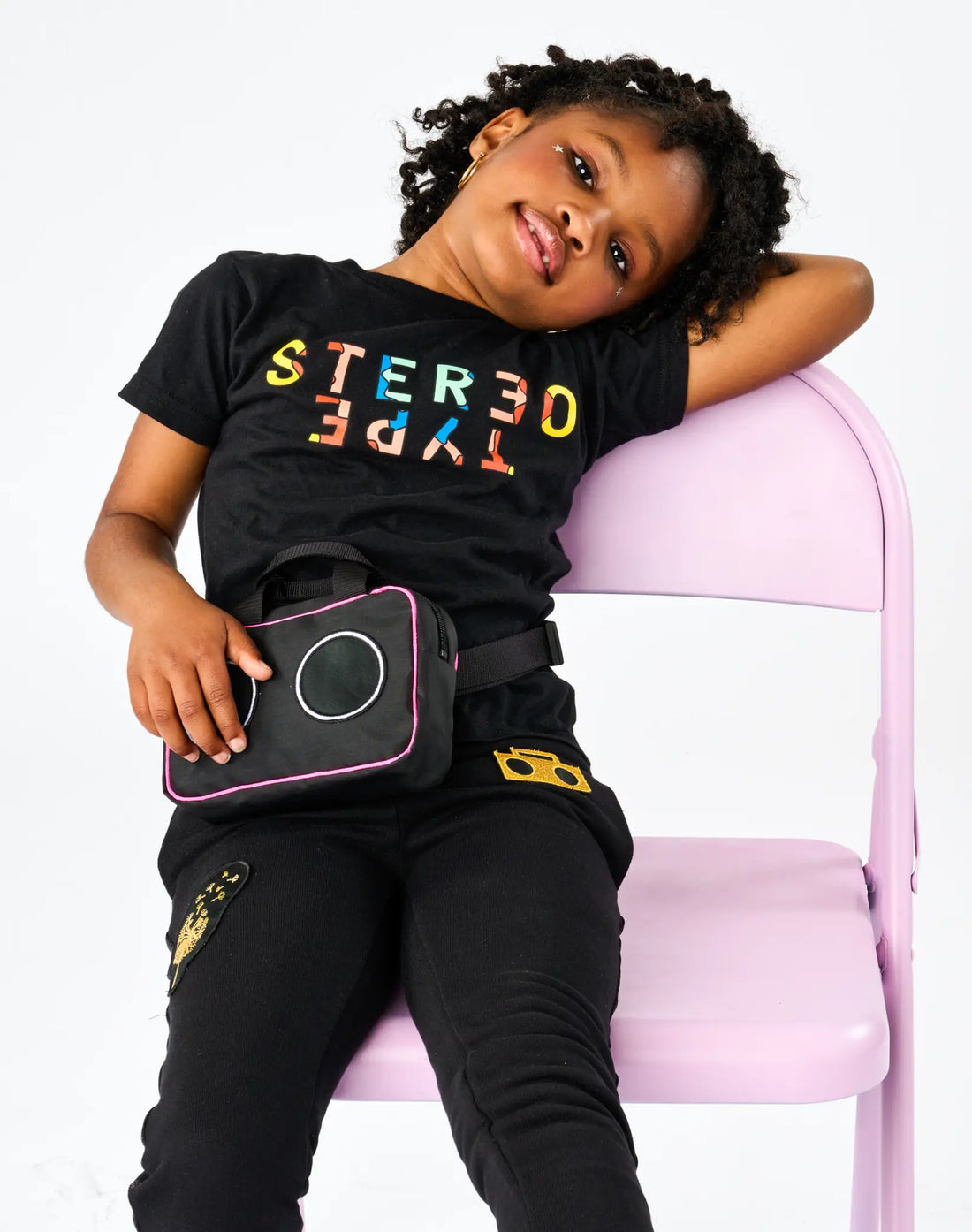 Child wearing StereoType Kids black Kaleidoscope Logo tee with Boombox Treasure Bag and Boombox Knit Sweats Pants