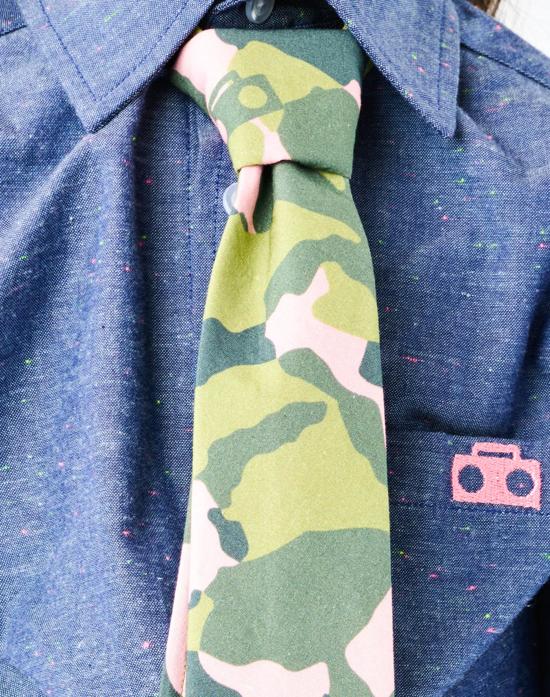 Stereotype Kids Zip Camo Tie closeup of adjustable zipper knot and floating boombox camo print, independent dressing for all kid 