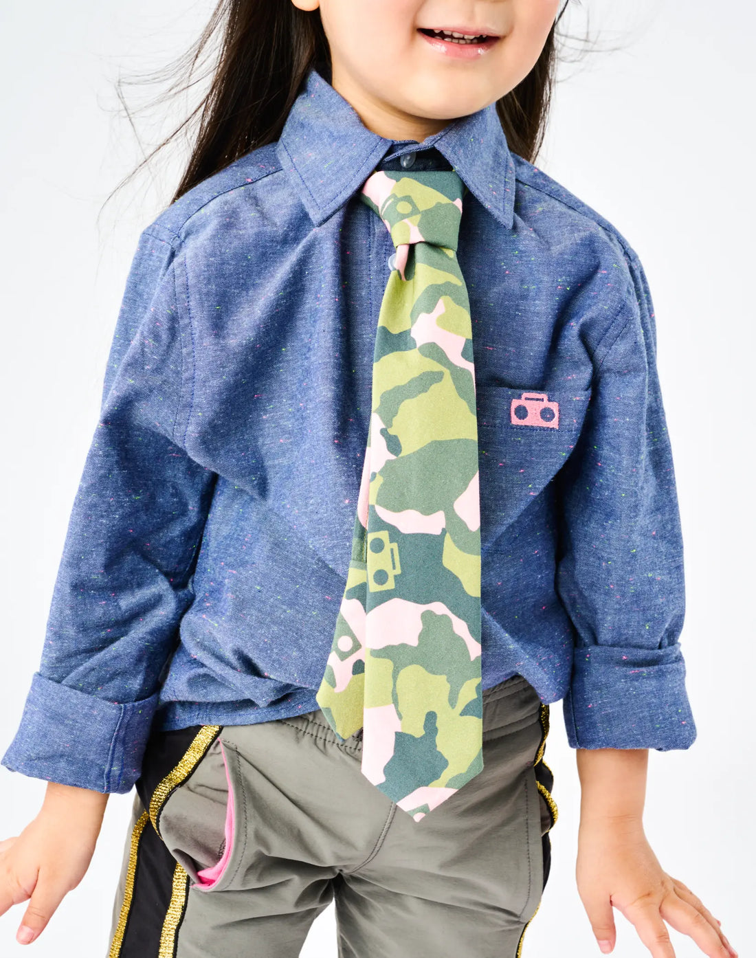 Stereotype Kids Zip Camo Tie in pink camo boombox print worn with chambray zip shirt, no-tie zipper design for independent dressing